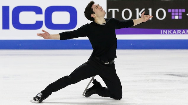 Keegan Messing, les bras tendus, pose le genou gauche sur la glace