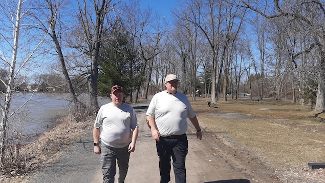 Deux hommes marchent dans un sentier