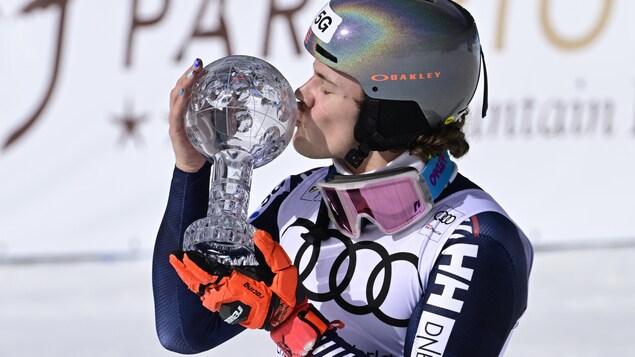 Le skieur Lucas Braathen embrasse son globe de cristal.