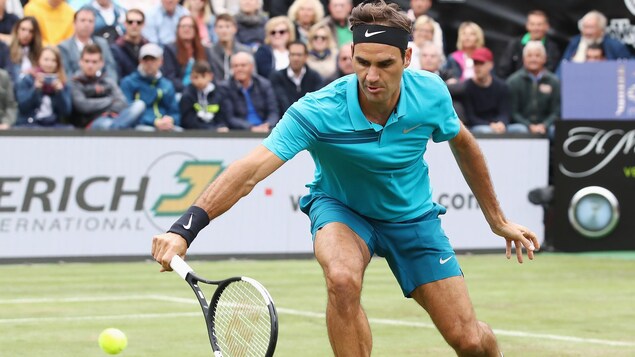 Roger Federer effectue un revers sur gazon. Roger Federer effectue un revers sur gazon.