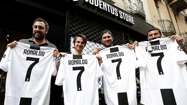 Quatre partisans de la Juventus affichent le nouveau chandail de Cristiano Ronaldo et son célèbre numéro 7. Quatre partisans de la Juventus affichent le nouveau chandail de Cristiano Ronaldo et son célèbre numéro 7.