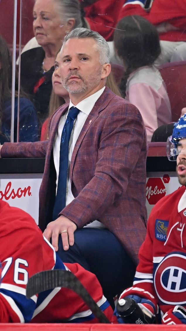 Un entraineur et des joueurs déçus au banc. 