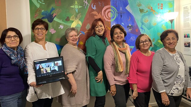 Un groupe de sept femmes d'origine latino-américaine sourient à la caméra. 