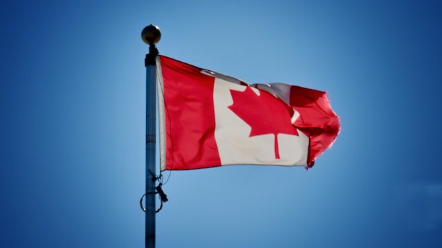 Canada flag. Canada’s goal is to provide permanent residency to 401,000 in 2021.