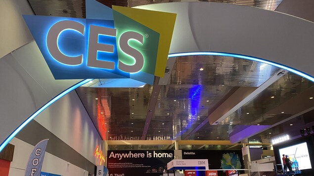 People walk through the lobby of the Las Vegas Convention Center during set up for CES 2022 in Las Vegas, Nev., on Monday. This year marks the first time the Consumer Electronics Show has been staged since before the pandemic began. 