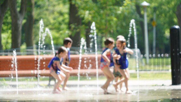 Children playing in a fountain.