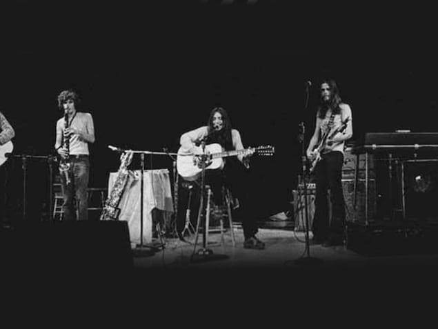 Five harmonium musicians, with their instruments in their hands, on a scene. serge fiori, founder harmonium, died