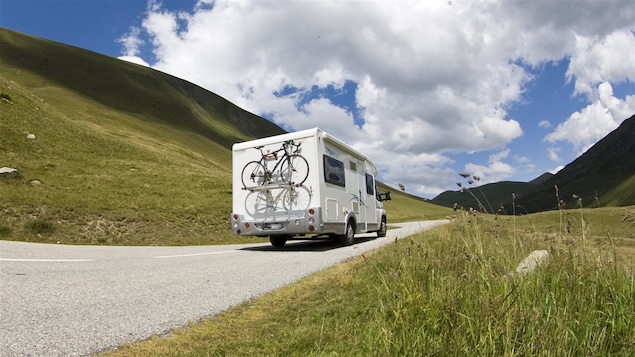 Une caravane sillonne une route panoramique.