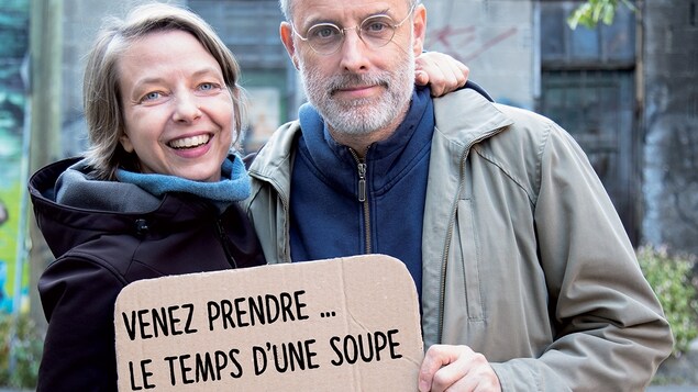 Annie Roy et Pierre Allard tiennent une affiche Annie Roy et Pierre Allard tiennent une affiche