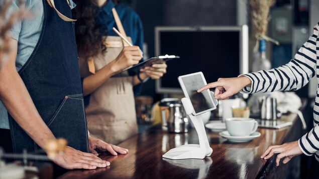 Des vendeurs et des consommateurs au comptoir d'une entreprise.