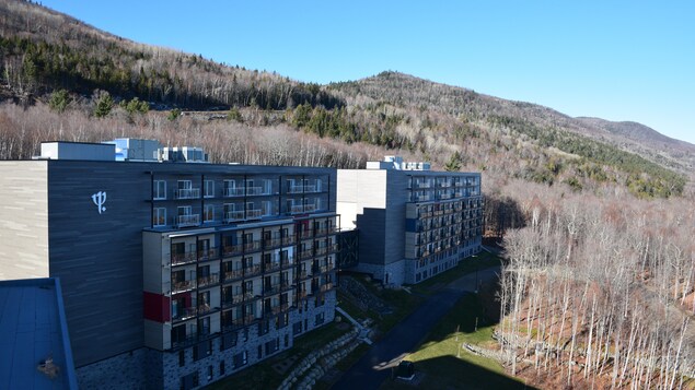 L'extérieur d'un hôtel dans la montagne, avec des teintes de gris.