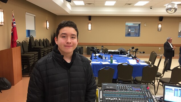 L'élève Drew Espinosa à côté de la console audio pendant immédiatement après l'émission spéciale de Grands Lacs café à Welland. 