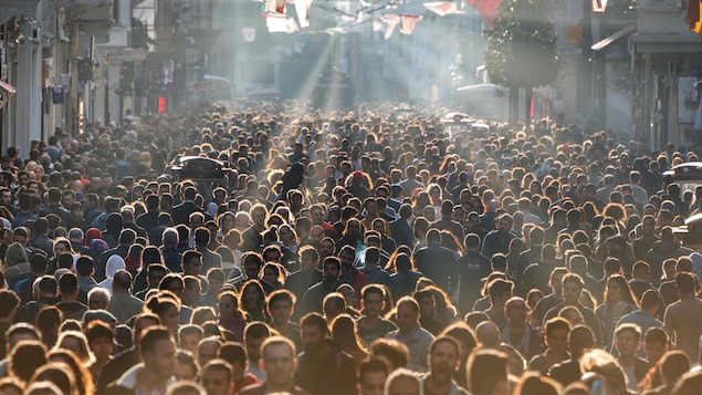 Une foule de personnes rassemblées dans une rue.