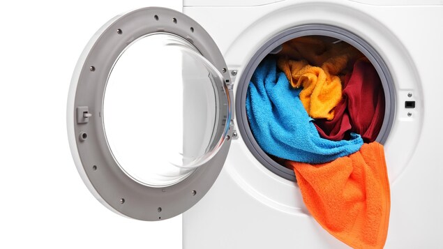 Une laveuse à chargement frontal remplie de linge.