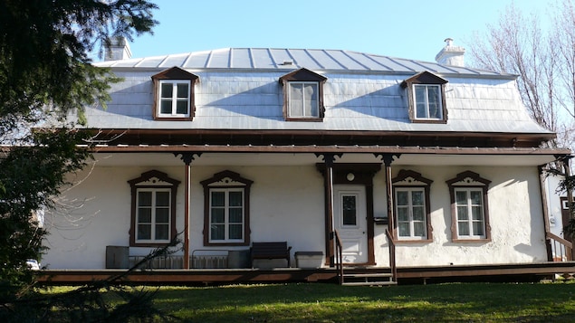 La maison Jobin-Bédard apparaît, avec ses trois lucarnes et son perron soutenu par des colonnes.