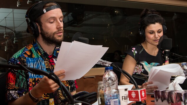 Les deux comédiens lisent leur texte sur des feuilles.
