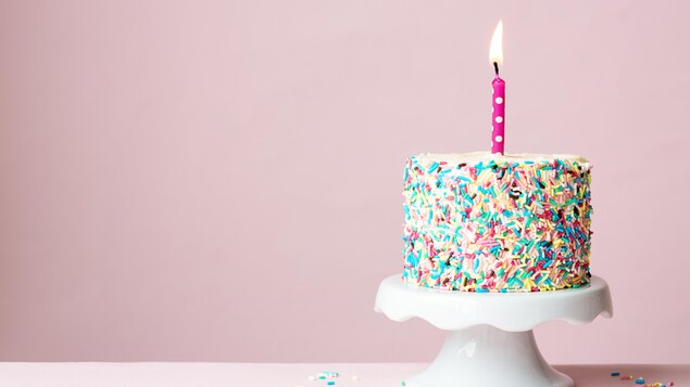 Cadeau d'anniversaire multicolore avec une bougie rose