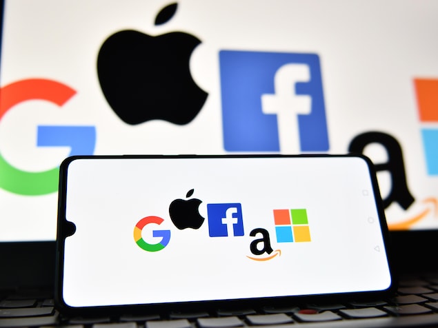 The logos of Google, Apple, Facebook, Amazon and Windows displayed on a smartphone and a laptop screen. Nevertheless,  carney renounces taxing digital giants