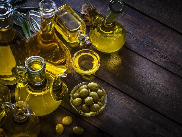 Des bouteilles d'huile d'olive disposées sur une table.