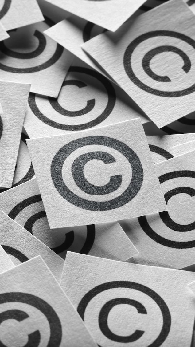 Signs of copyright on paper. ai can train books without
