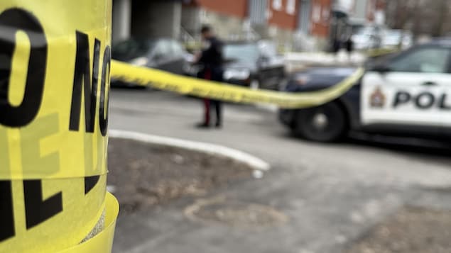 Une auto-patrouille du Service de police d'Ottawa et un ruban jaune qui délimite une scène de crime.