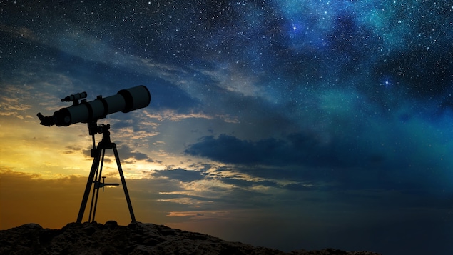 Un télescope pointé vers un ciel étoilé.
