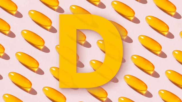 Illustration de la lettre « D » sur un arrière-plan de gélules.
