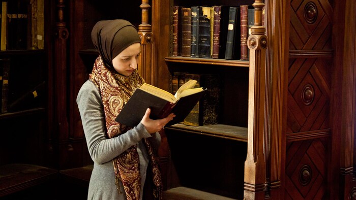 A woman reading in a library.