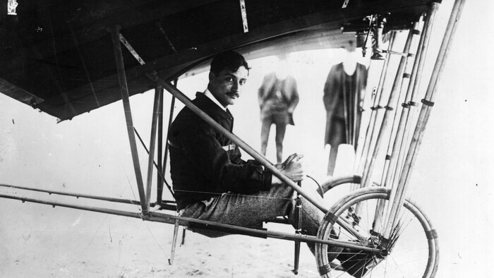 Photo en noir et blanc du pilote assis dans son appareil.