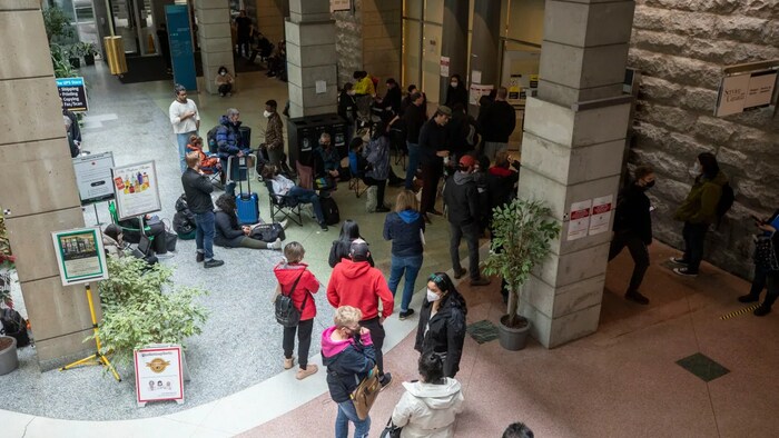 People are pictured in long lineups at the passport office in downtown Vancouver on April 20.