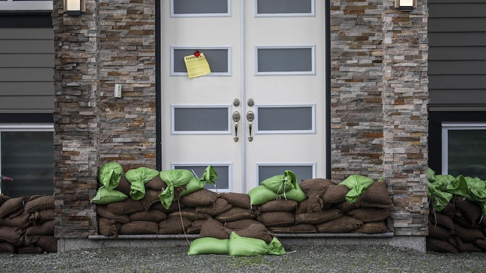 A house is pictured surrounded by sandbags to prevent floodwater in the Sumas Prairie flood zone in Abbotsford. Numerous volunteers have banded together to help those in the community affected by floods.