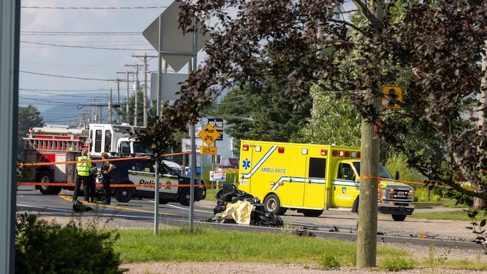 Emergency Service Vehicles Near The Crashed Motorcycle Lying On The Ground.