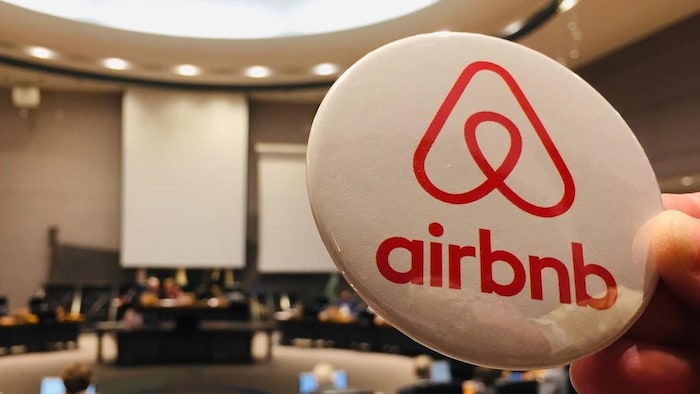 An Airbnb logo on a pin.