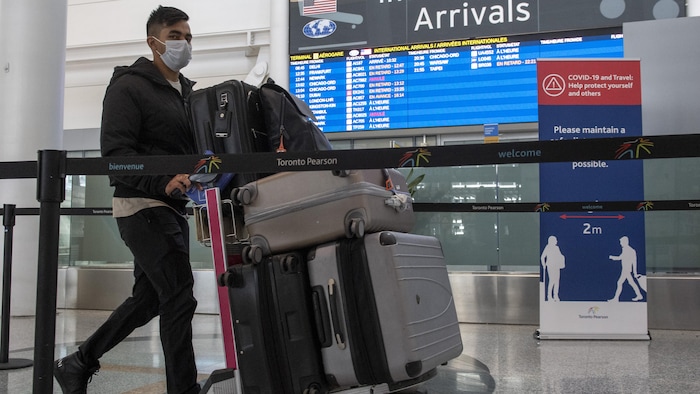 A passenger from Air India flight 187 from New Delhi arrives at Pearson Airport in Toronto on Wednesday April 21, 2021. THE CANADIAN PRESS/Frank Gunn