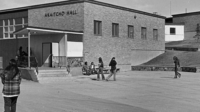 Une image en noir et blanc d'élèves sur le terrain d'Akaitcho Hall à Yellowknife.