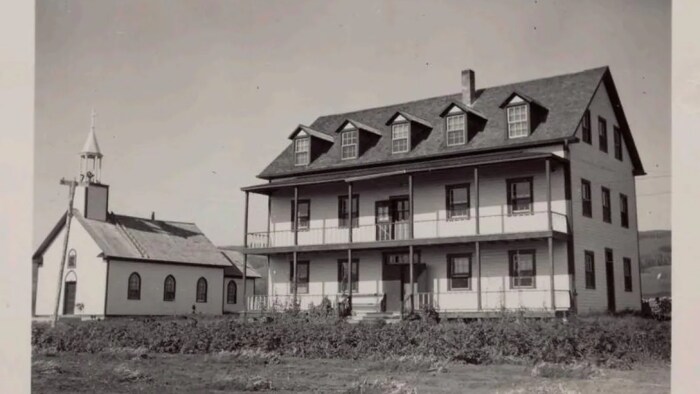 Archive photograph of St. Augustine Residential School and its church nearby (Smoky River).