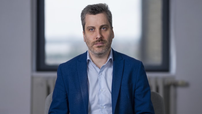 L'avocat et analyste chez Option consommateurs, Alexandre Plourde assis devant la caméra.