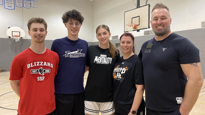 A family taking a break in a gym.