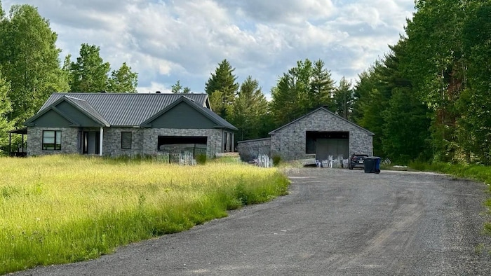 A house and trees in the background.