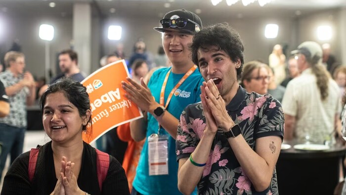 Earlier Monday night, NDP supporters nervously watch the results of the Alberta election in Edmonton. (Jason Franson/The Canadian Press)