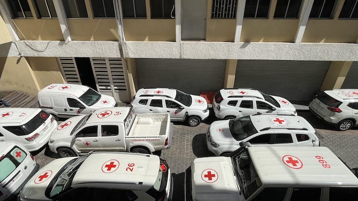 Red Cross vehicles parked.