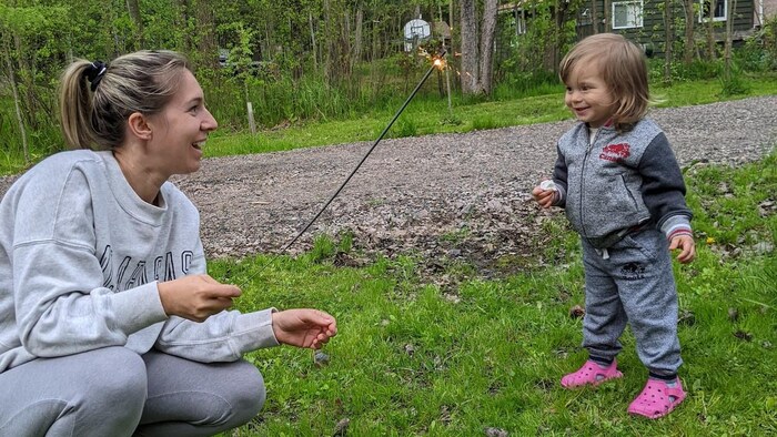 Anneliese Lawton is pictured with her two-year-old daughter. The Toronto mother said she cannot afford full-time summer camp for her kids this year as inflation has stretched her family budget.