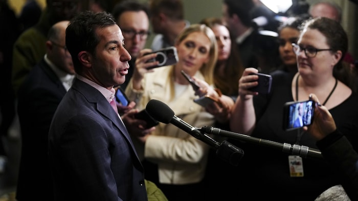 Anthony Housefather answers reporters' questions during a press scrum.