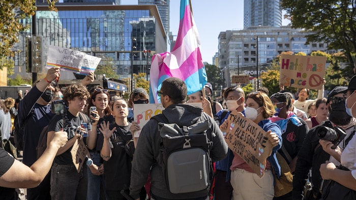 Demonstrators from pro-SOGI (sexual orientation and gender identity) protests confront an anti-SOGI protester in Vancouver, B.C, on Wednesday, September 20, 2023.