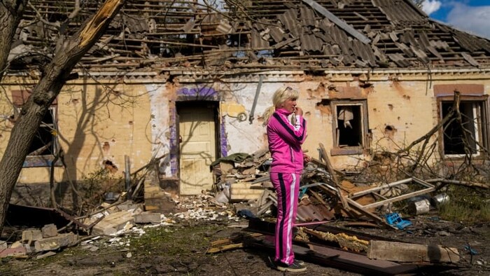 Iryna Martsyniuk, 50, stands next to her house, heavily damaged by Russian bombing, in Velyka Kostromka village, Ukraine on May 19, 2022. (Associated Press/Francisco Seco)