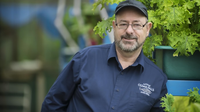 Steve Atkinson in front of a plant.
