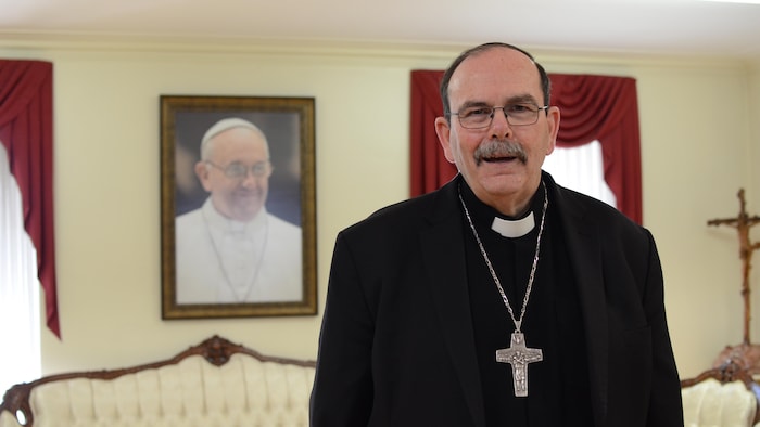 L'archevêque de Saint-Boniface, Albert LeGatt, devant une photo encadrée du pape François.