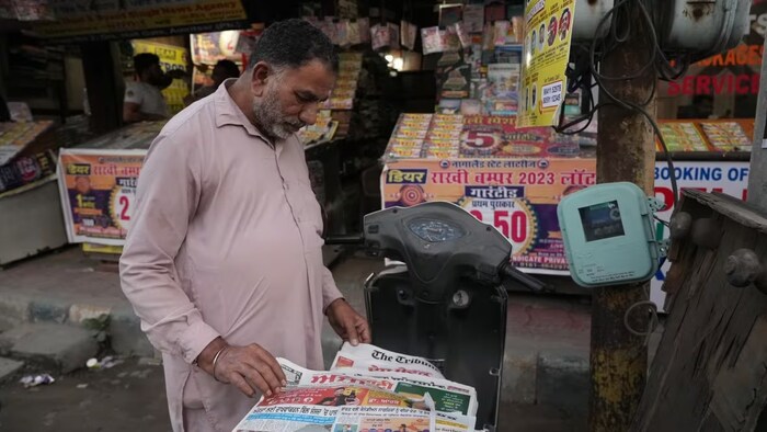 Newspaper vendor Ashok Kumar tends to his stand in Amritsar on Saturday. Kumar has had a busy week, with many people in India's northern Punjab state anxious to keep up with the diplomatic twists and turns of the deepening tensions between India and Canada. (Salimah Shivji/CBC News)