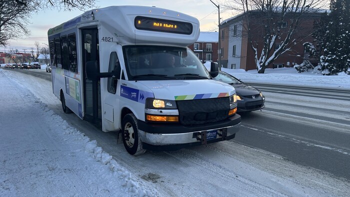 Un autobus de transport de voyageurs arrive à la station.