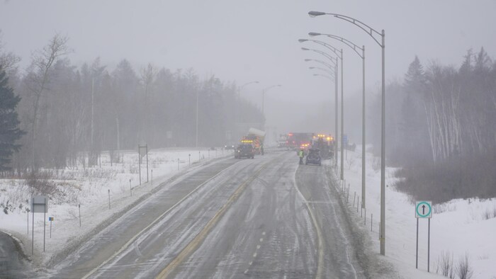        Des véhicules d'urgence dans la neige sur l'autoroute.                        
